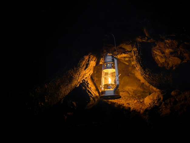 Lanterna amarela pendurada na entrada da caverna