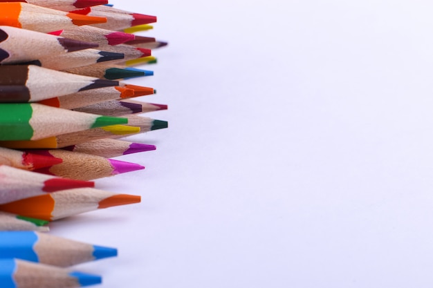 Foto lápices de colores se encuentran en una fila en blanco