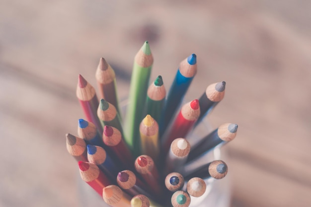 Lápis de cor de criatividade em uma lata na mesa de madeira rústica