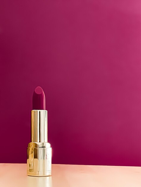 Lápiz labial morado en tubo dorado sobre fondo de color maquillaje de lujo y cosméticos para el diseño de productos de marca de belleza