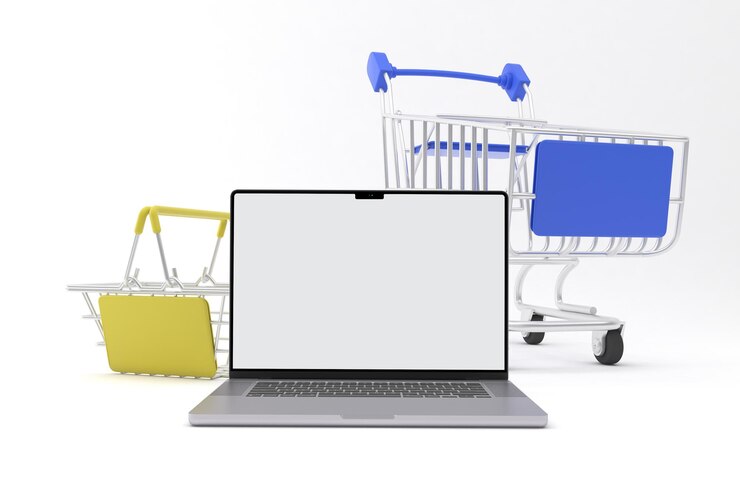Foto laptop y carritos de compras en la parte delantera en fondo blanco.