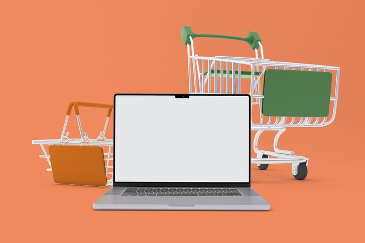 Foto laptop y carritos de compras en la parte delantera en fondo naranja