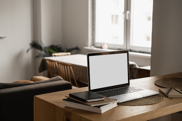 Laptop com tela de espaço de cópia em branco na mesa com notebooks na mesa de madeira