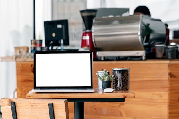 Laptop-Computer mit leerem Bildschirm auf Holztisch im Café.