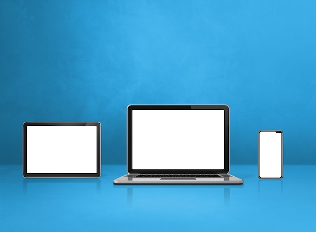 Foto laptop, handy und digitaler tablet-pc auf blauem schreibtisch. 3d-illustration
