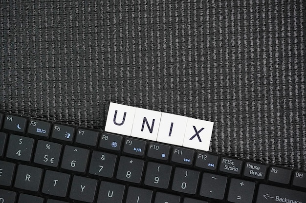 Laptop keyboard with the word UNIX Unix is a family of multitasking multiuser computer operating sys