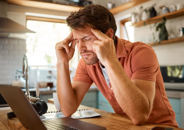 Laptop mit Kopfschmerzen und Geschäftsmann in der Küche für Fernarbeit, Freiberufler und psychische Gesundheit. Technologiefehler, müde und frustriert, weil die Person zu Hause an Burnout, Erschöpfung und Angst denkt