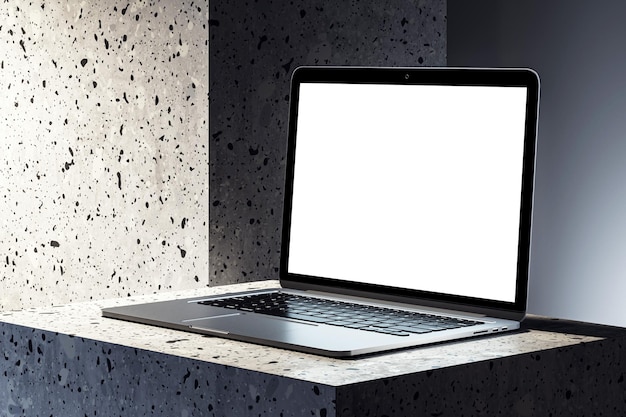 Laptop moderno con pantalla en blanco en un pedestal de piedra con textura Rendering 3D