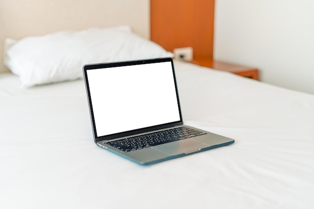 Laptop na cama vaziaMulher caucasiana deitada na cama usando laptop