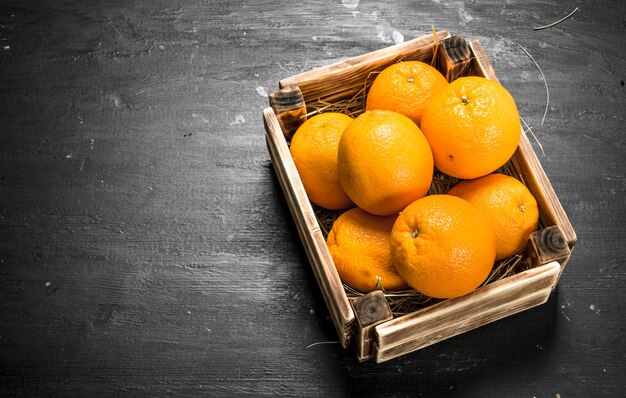 Laranjas frescas em uma caixa velha.