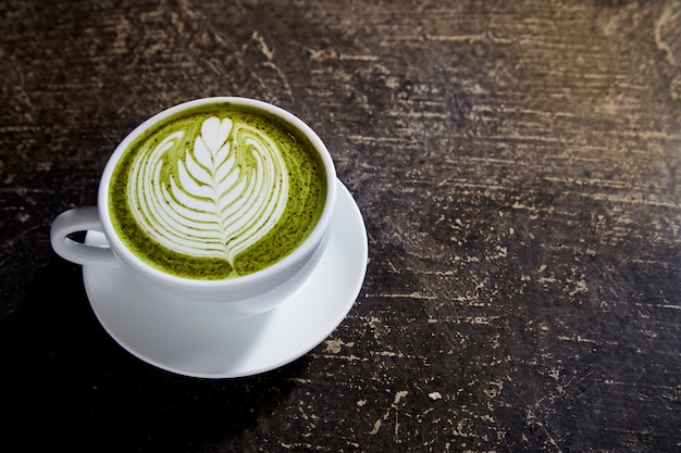 Latte de té matcha en mesa negro