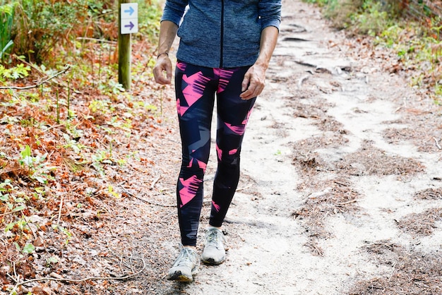 Laufende Frau, die ein gesundes Lebensstilkonzept im Naturweg-Waldpark durchführt