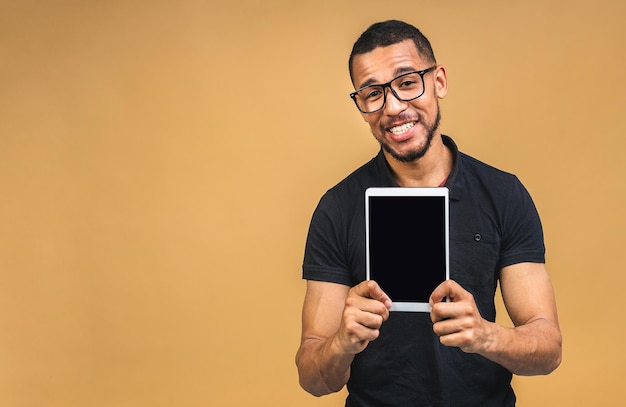 Laughing Young African American black man Holding a Touch Pad Tablet PC