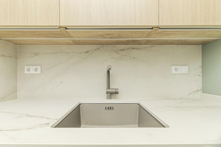 Foto lavabo de cozinha minimalista com superfícies lisas, linhas retas e poucos ornamentos