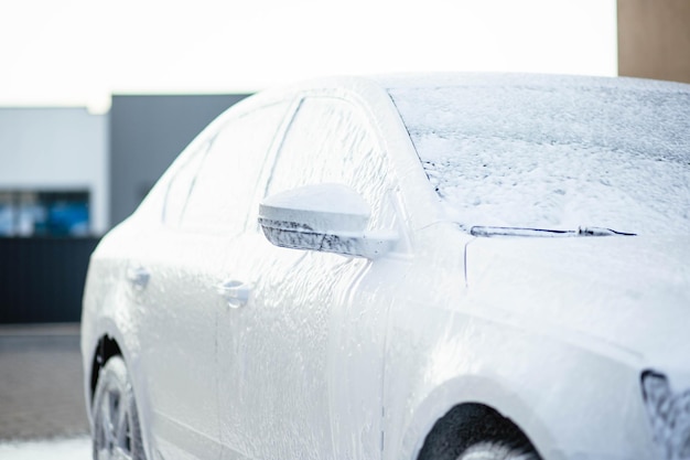Lavado de autos de verano Limpiar el auto con agua a alta presión Lavado de autos con jabón Concepto de primer plano Medidas de seguridad durante la epidemia Concepto de desinfección y limpieza antiséptica Lavado de autos
