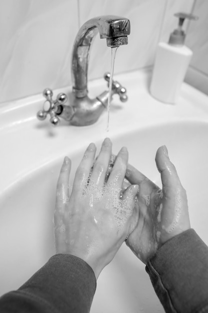 Lavarse las manos frotando con jabón para la prevención del coronavirus foto en blanco y negro