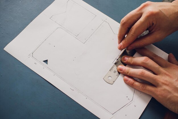 leather craftsman working making products at table in workshop studio