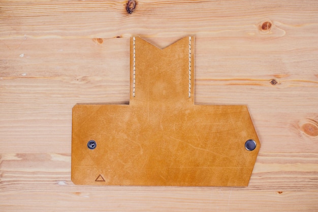leather craftsman working making products at table in workshop studio
