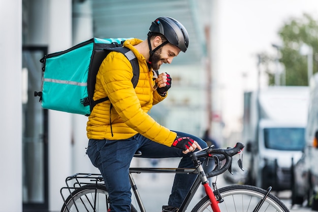 Lebensmittellieferservice, Fahrer, der Lebensmittel mit dem Fahrrad an Kunden liefert - Konzepte zu Transport, Lebensmittellieferung und Technologie