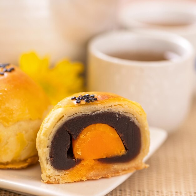 Lecker gebackener Eigelb-Gebäck-Mondkuchen für MidAutumn Festival auf hellem Holztischhintergrund Chinesisches festliches Essenskonzept Nahaufnahme Kopierraum