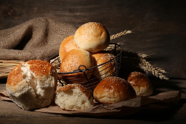 Leckere Brötchen mit Sesam auf Holzhintergrund