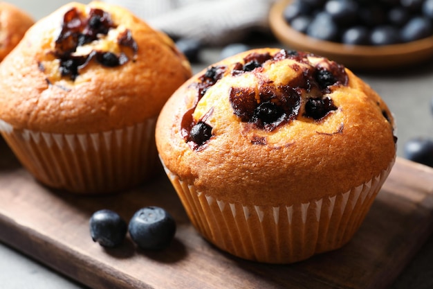 Leckere Heidelbeermuffins auf Holzbrett Nahaufnahme