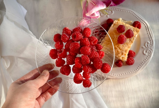 Leckere Himbeeren auf Teller und Blätterteig mit Himbeere auf Teller