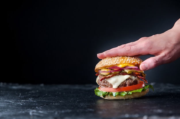 Leckerer frischer hausgemachter Burger in Händen