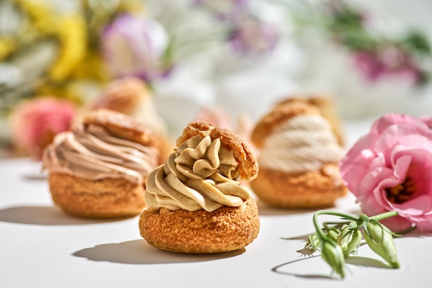 Leckerer Kuchen Shu oder Eclairs mit Sahne auf weißem Hintergrund mit Kopierraum