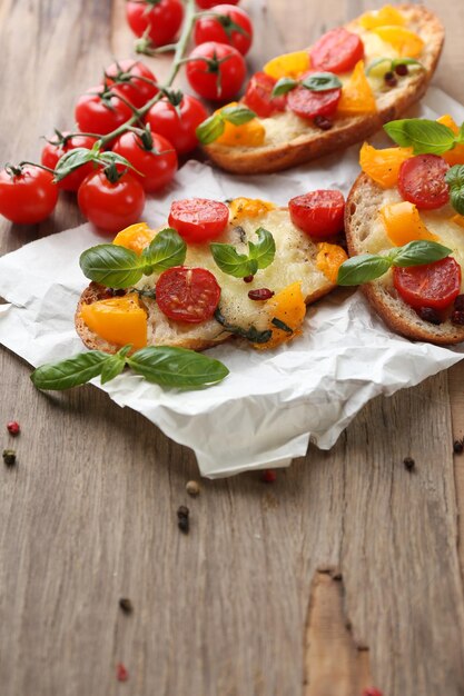 Leckeres Bruschetta mit Tomaten auf altem Holztisch