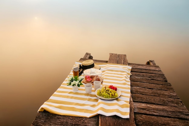 Leckeres Essen für ein Picknick im Freien in der Nähe des nebligen Sees bei Sonnenaufgang