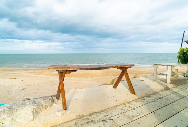 leere Holzbank am Strand mit Seestrandhintergrund