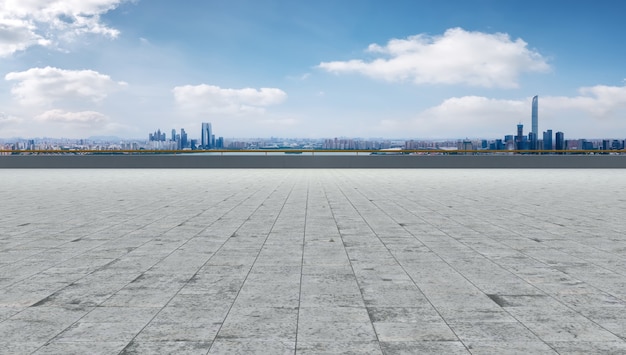 Leerer Backsteinboden mit Skyline-Hintergrund der Stadt