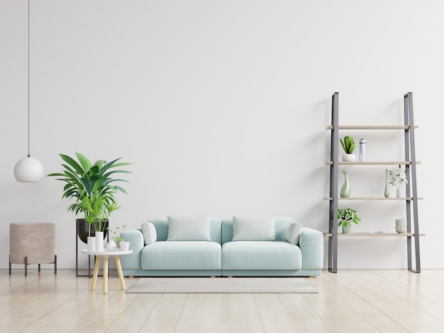 Leeres Wohnzimmer mit blauem Sofa, Pflanzen und Tabelle auf leerem weißem Wandhintergrund.