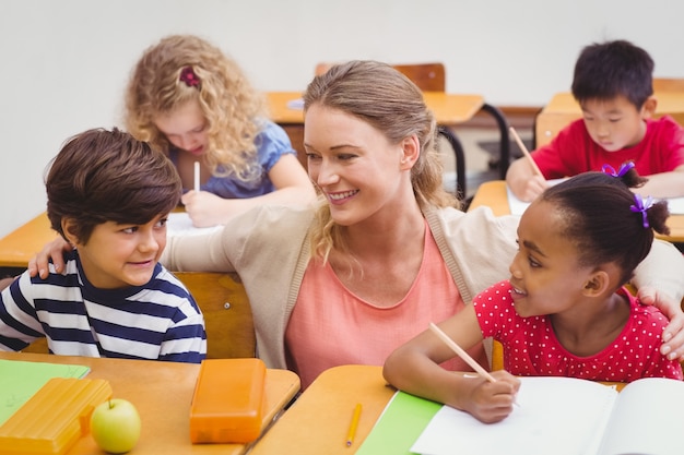 Lehrer und Schüler arbeiten am Schreibtisch zusammen