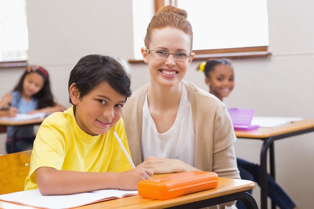 Lehrer und Schüler, die an der Kamera lächeln