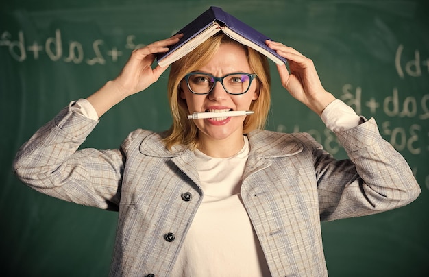 Lehrerin mit Buch als Dach auf dem Kopf Methode zum Auswendiglernen Trainieren Sie jeden Tag das Gedächtnis Effektive Methode, um sich an Informationen zu erinnern Wichtige Informationen zu vergessen Im Gedächtnis zu bleiben Verbessern Sie die Gedächtnisfähigkeit