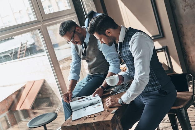 Leidenschaftlich für die Arbeit. Hübscher junger Mann, der mit seinem Kunden Design wählt