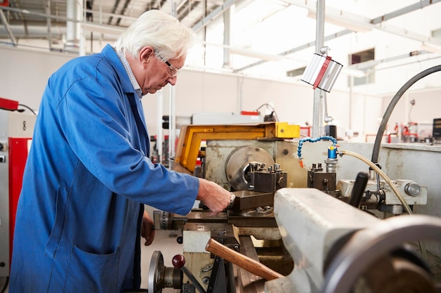 Leitender Ingenieur, der in einer Seitenansicht der Fabrik arbeitet