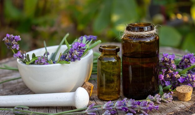 Óleo de ervas e flores de lavanda em um fundo de madeira Foco seletivo da natureza