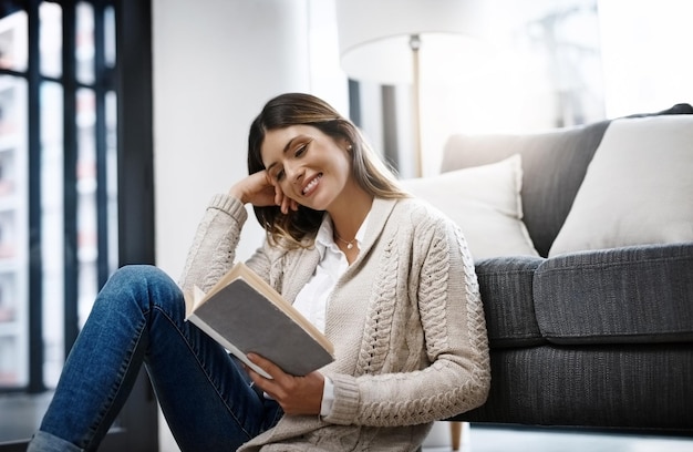 Lesen ist meine Lieblingsbeschäftigung in meiner Freizeit Schnappschuss einer schönen jungen Frau, die ein Buch liest, während sie sich zu Hause entspannt