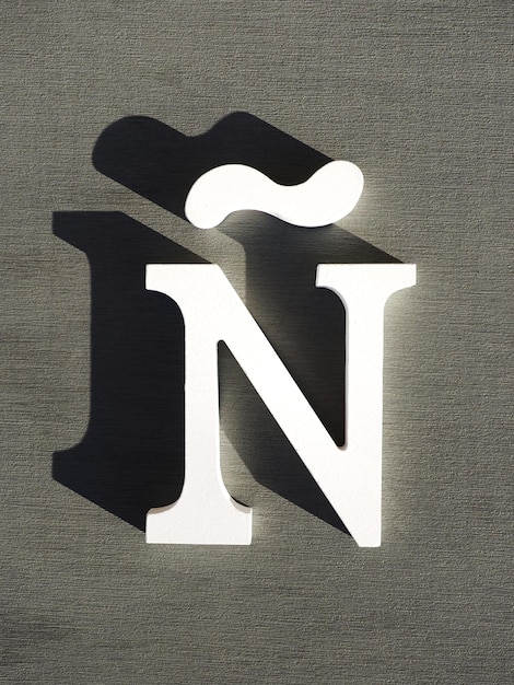 Letra blanca de madera en un fondo gris Ene símbolo de la lengua española