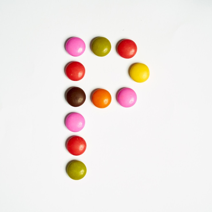 Foto letra p de caramelos de colores dulces, alfabeto aislado sobre fondo blanco. pags.