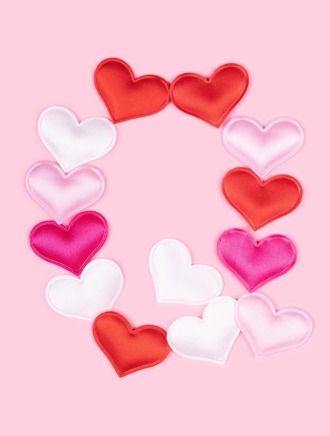Letra Q feita de corações de atlas brilhantes isolados em fundo rosa sólido fonte de corações do alfabeto do amor