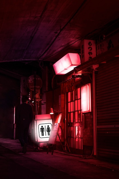 Foto letrero de baño con luz de neón en la noche