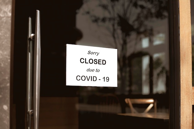 El letrero frente a la oficina está cerrado temporalmente Firme Coronavirus en la tienda