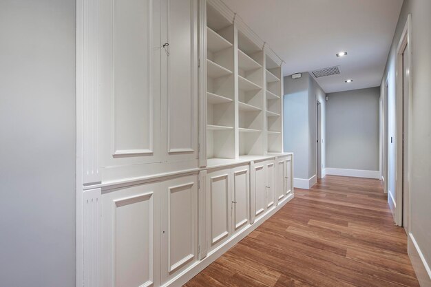 Foto librería de madera lacada a medida en pasillo de casa