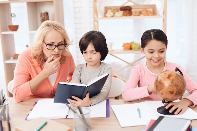 Libro de lectura del nieto con la tarea de la abuela