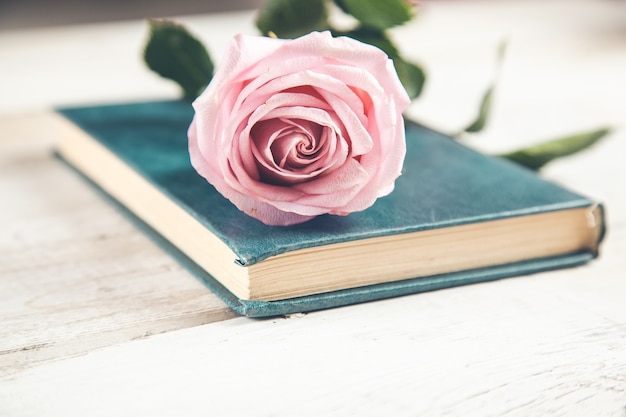 Foto libro con rosas en la mesa de madera