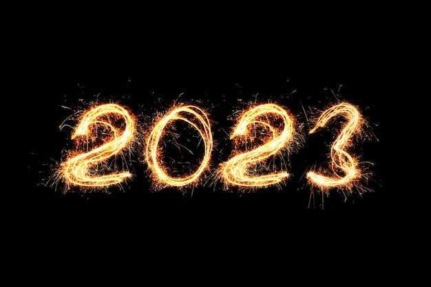 Licht des neuen Jahres 2023. Wunderkerzen zeichnen Figuren 2023. Bengalische Lichter und Buchstaben